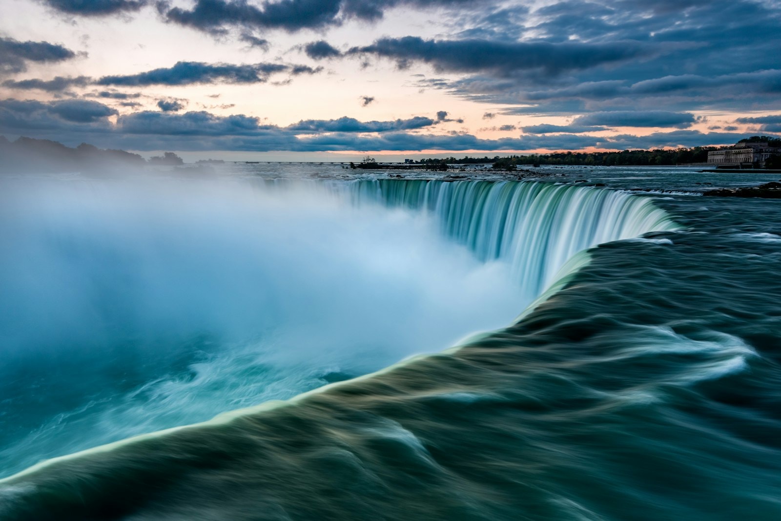 Niagara Falls at sunrise with mist over the gorge